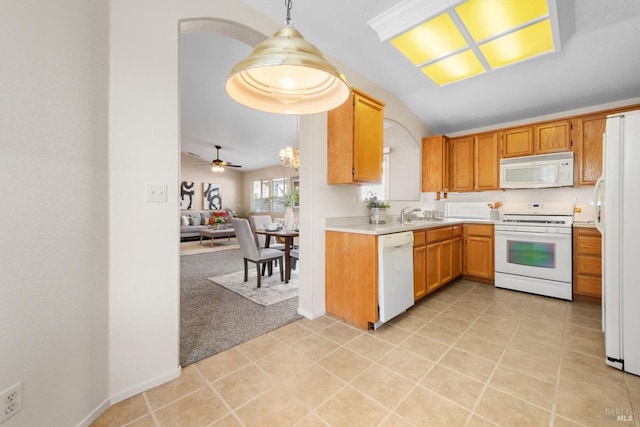 kitchen with open floor plan, light colored carpet, light countertops, hanging light fixtures, and white appliances