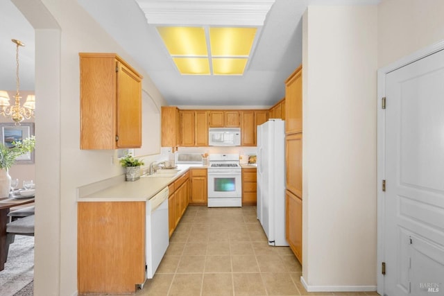 kitchen featuring a chandelier, light countertops, light tile patterned floors, white appliances, and a sink