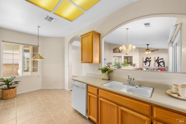 kitchen featuring a sink, visible vents, arched walkways, and dishwasher