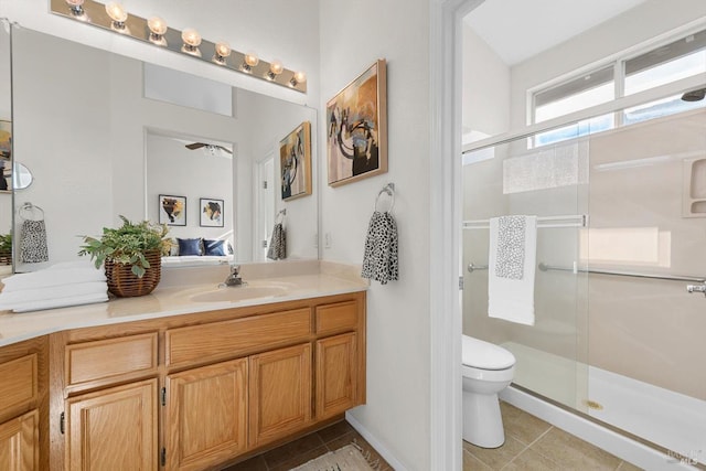 full bath featuring tile patterned flooring, a stall shower, toilet, and vanity