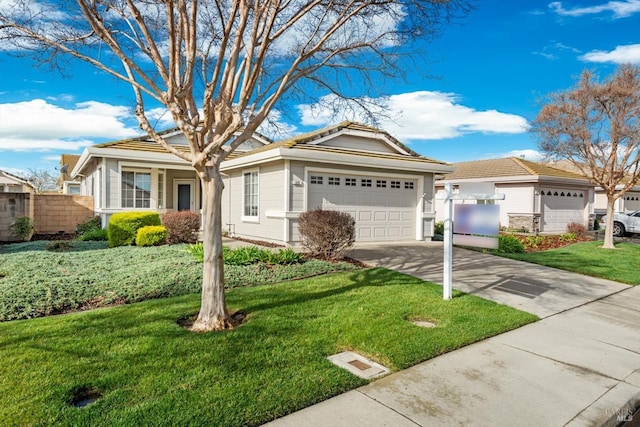 ranch-style house featuring a front yard, fence, a garage, and driveway