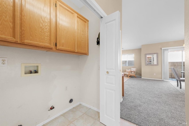 clothes washing area with light carpet, cabinet space, baseboards, and hookup for a gas dryer