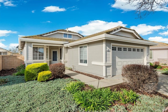 view of front of property with an attached garage and fence