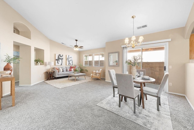 dining area with visible vents, ceiling fan with notable chandelier, lofted ceiling, and carpet floors