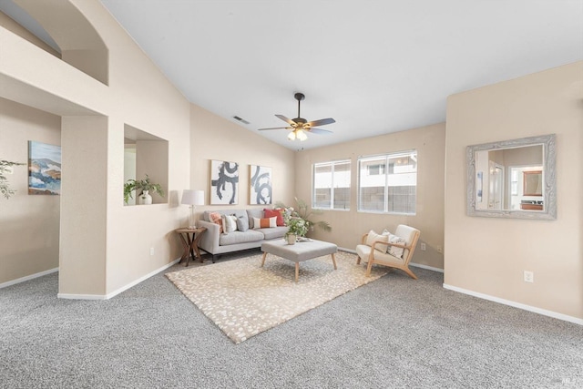 carpeted living room with visible vents, baseboards, ceiling fan, and vaulted ceiling