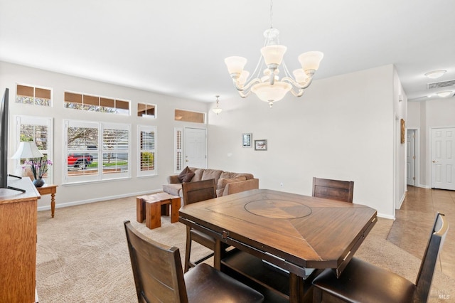 dining room with light carpet, an inviting chandelier, baseboards, and visible vents