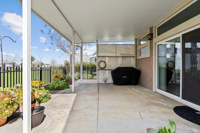 view of patio featuring area for grilling and fence