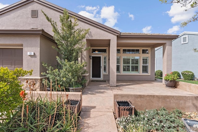 entrance to property with stucco siding