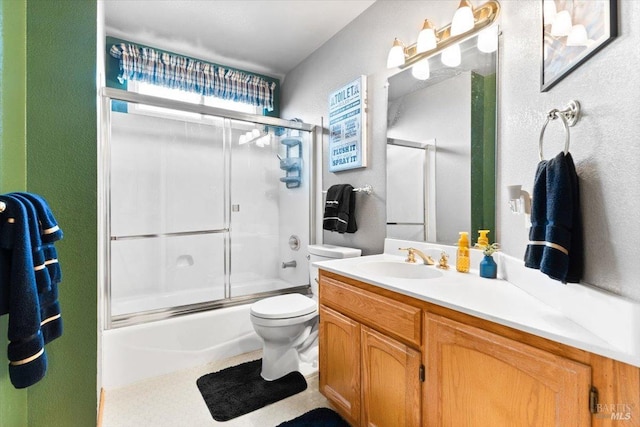 bathroom with enclosed tub / shower combo, toilet, and vanity
