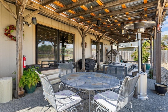view of patio featuring fence and outdoor dining area