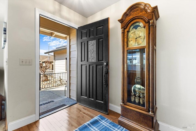foyer entrance featuring wood finished floors and baseboards