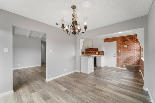 kitchen with light wood-style flooring, open floor plan, and light countertops