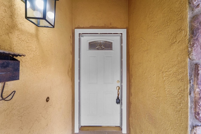 entrance to property with stucco siding