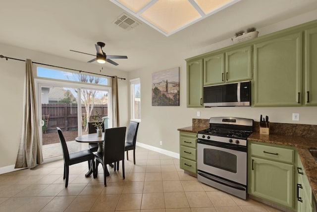 kitchen featuring appliances with stainless steel finishes, baseboards, visible vents, and green cabinets