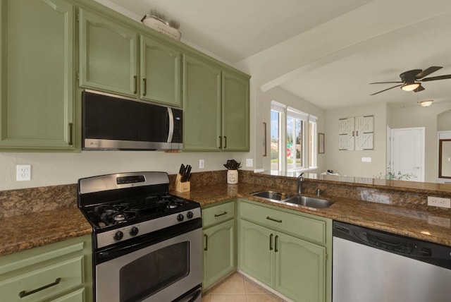 kitchen with appliances with stainless steel finishes, light tile patterned flooring, a sink, and green cabinets