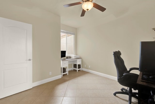 office space featuring light tile patterned flooring, a ceiling fan, and baseboards