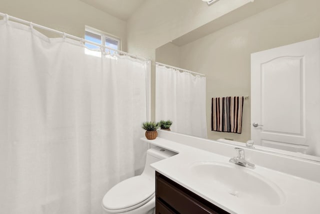 bathroom featuring toilet and vanity