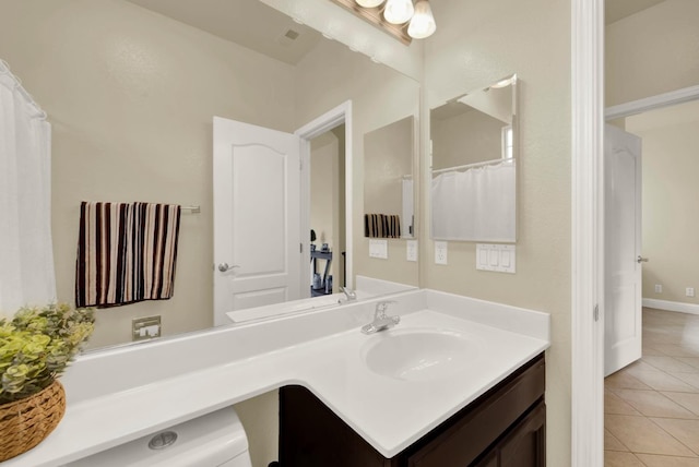 bathroom featuring tile patterned flooring and vanity