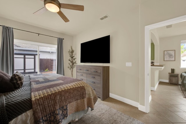 bedroom with light tile patterned floors, visible vents, and baseboards