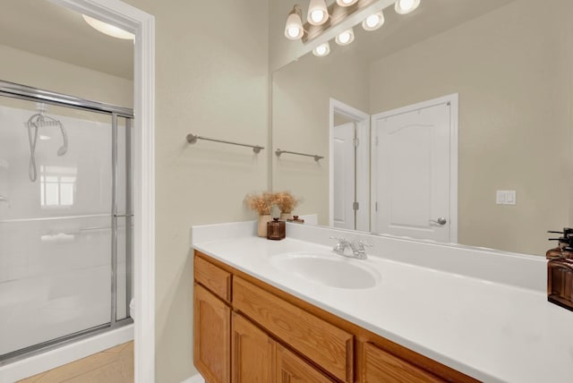 bathroom featuring a shower stall and vanity