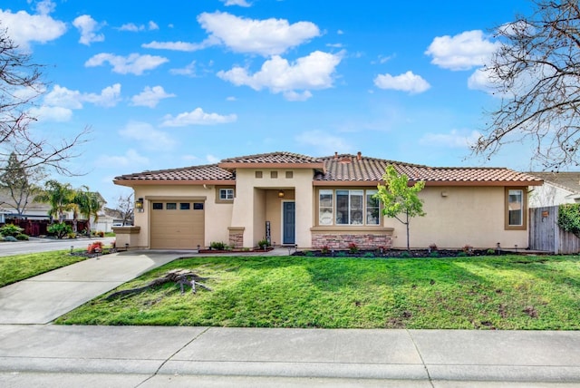 mediterranean / spanish-style house featuring a garage, concrete driveway, a tiled roof, a front lawn, and stucco siding