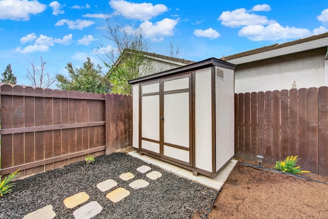 view of shed with a fenced backyard