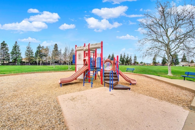 community jungle gym featuring a lawn