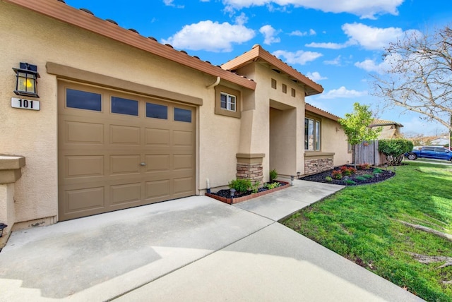 view of front facade with a garage, a front yard, concrete driveway, and stucco siding