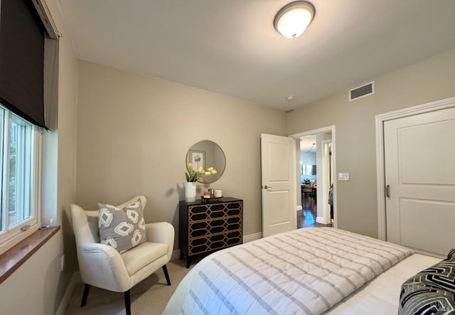 bedroom with carpet flooring, visible vents, and baseboards