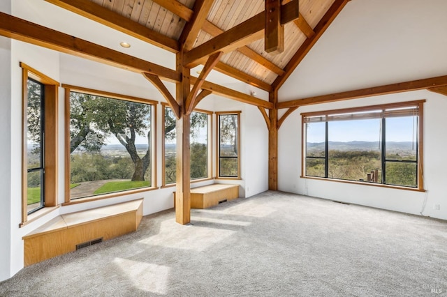 unfurnished sunroom with vaulted ceiling with beams and visible vents