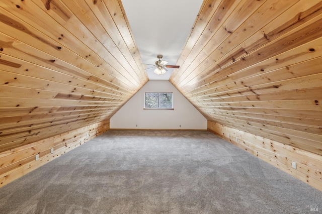 bonus room featuring wooden ceiling, carpet flooring, vaulted ceiling, and wooden walls