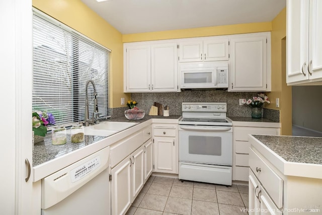 kitchen featuring a sink, white appliances, white cabinetry, and light tile patterned floors