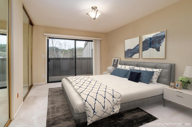 carpeted bedroom featuring baseboards and access to outside