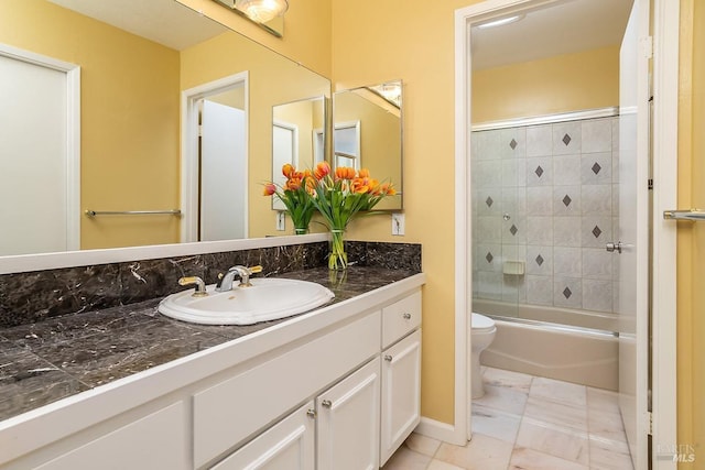 bathroom with toilet, vanity, and shower / bath combination with glass door