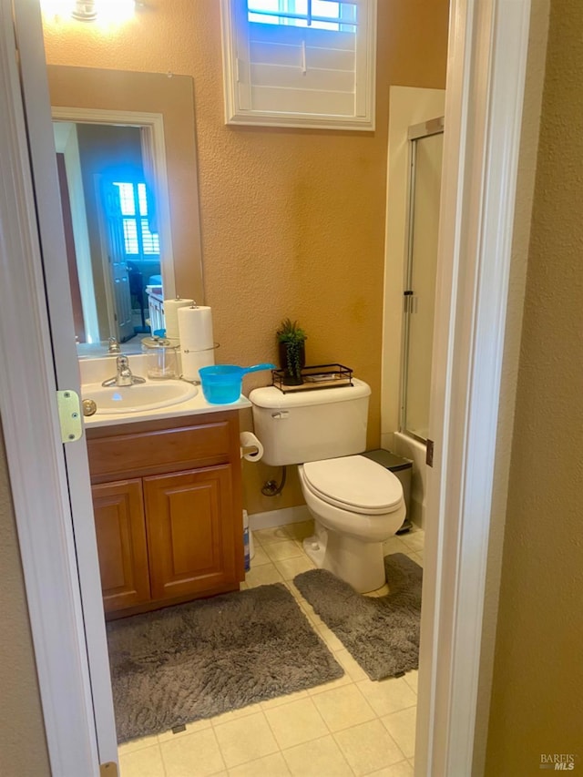 bathroom with tile patterned floors, plenty of natural light, toilet, and a shower stall