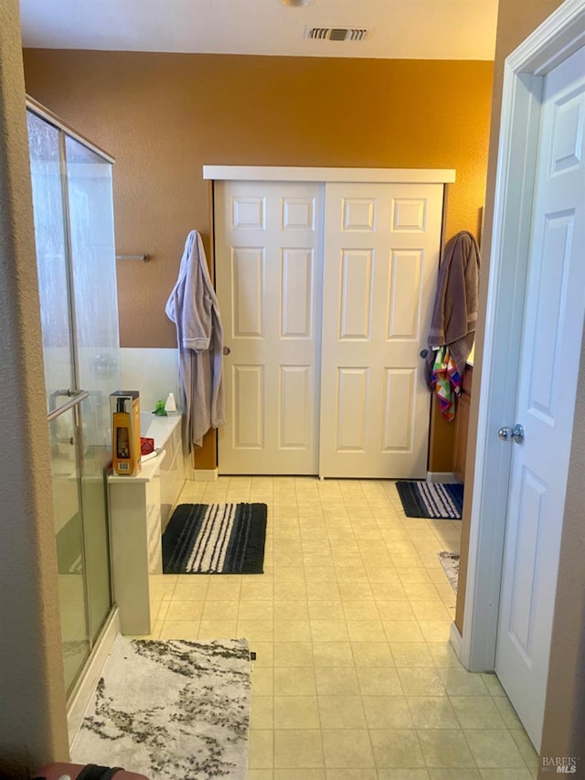 full bath with a tub, visible vents, and a shower stall