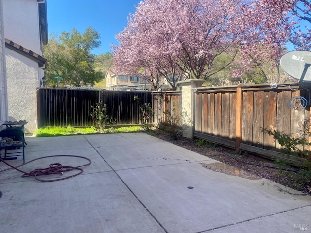 view of patio featuring fence