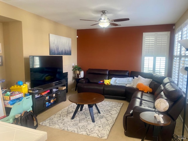 living room featuring light carpet and ceiling fan