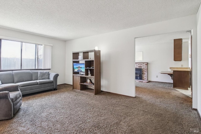 carpeted living room featuring a fireplace and a textured ceiling