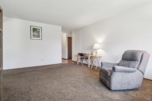 living area with a textured ceiling and carpet flooring