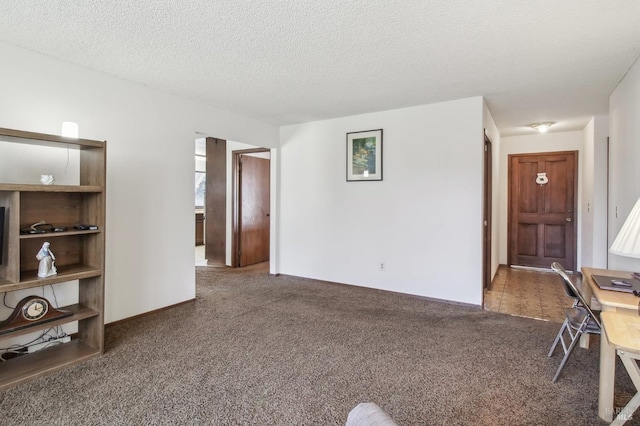 carpeted living area with a textured ceiling