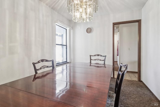 carpeted dining area featuring an inviting chandelier