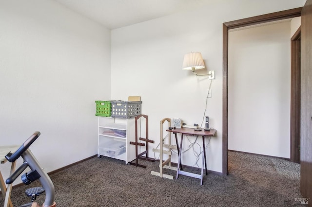 misc room with baseboards and dark colored carpet