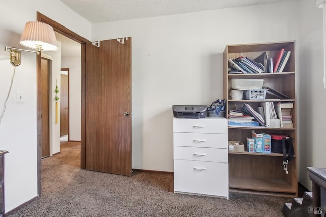 interior space with carpet, baseboards, and a textured ceiling