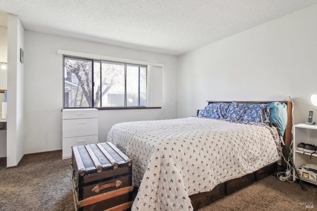 carpeted bedroom featuring a textured ceiling