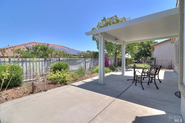 view of patio / terrace featuring outdoor dining area, a fenced backyard, and a mountain view