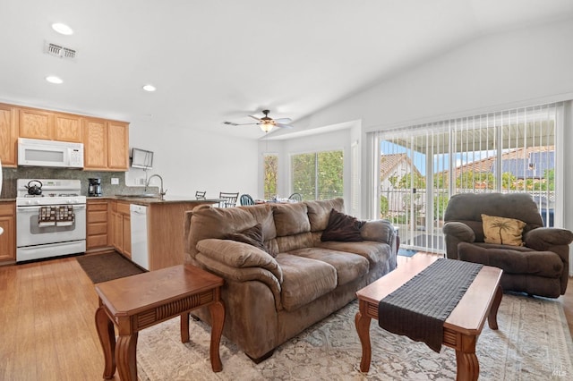 living room featuring light wood finished floors, recessed lighting, visible vents, vaulted ceiling, and ceiling fan