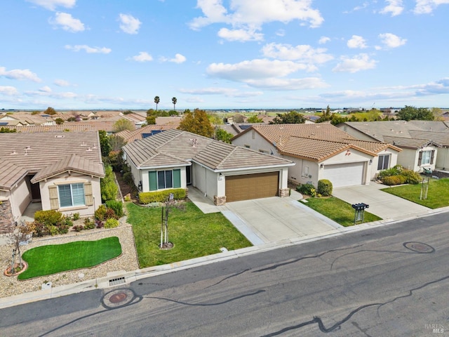 ranch-style home with stucco siding, an attached garage, a front yard, a residential view, and driveway