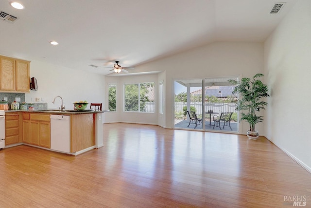 kitchen with white appliances, a sink, visible vents, open floor plan, and light wood-type flooring