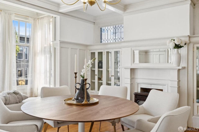 2401 Jackson St Unit 3, San Francisco, CA 94115 - dining area featuring a chandelier, a fireplace, a decorative wall, beam ceiling, and crown molding